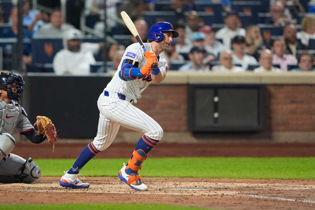 Jeff McNeil injury Mets: Man in white baseball uniform follows through on swing