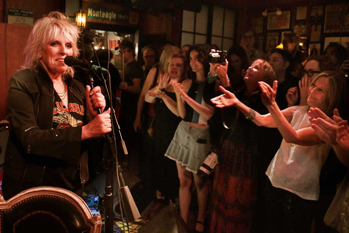 woman singing on stage as fans applaud at Lucinda's in East Village