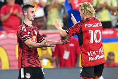 two Red Bulls players celebrate game-winning goal