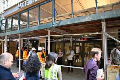 people near a construciton area at a subway station
